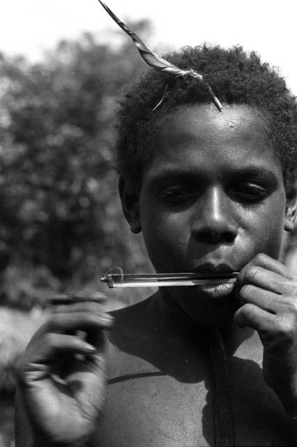 Isele plays bamboo mouth harp.