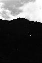 Man silhouetted on summit of Dugum Hill shouting into Valley