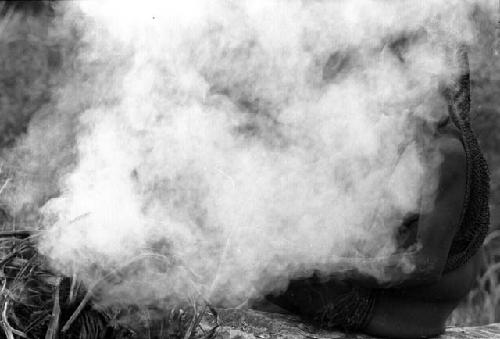 Woman burning salt on rock above Wubakaima.