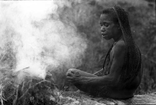 Woman burning salt on rock above Wubakaima.