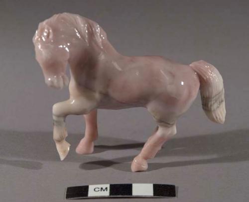 Fetish horse of pink stone, prancing