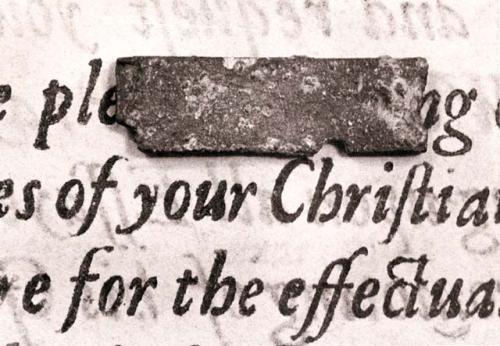 Printing type resting on passage from Marmaduke Johnson's printing of John Eliott's The Indian Grammar, Cambridge, MA, 1666.