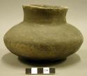 Ceramic vessel, short, flared neck, incised design at base