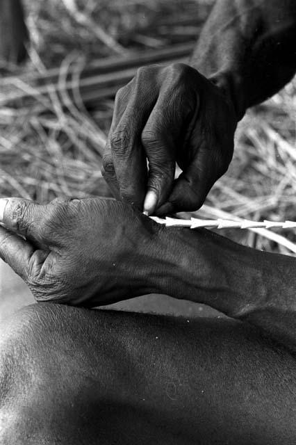 Karl Heider negatives, New Guinea; Man barbing arrow