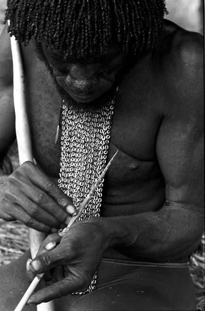 Karl Heider negatives, New Guinea; Man barbing arrow