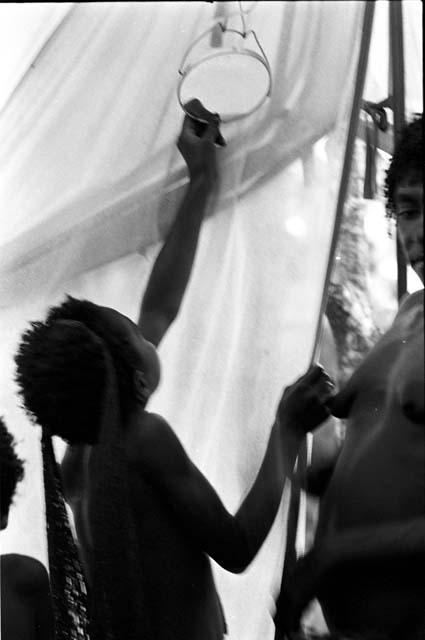 Karl Heider negatives, New Guinea; Young girls look in MR's mirror