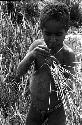 Karl Heider negatives, New Guinea; Milika's son making grass stem toys