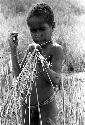 Karl Heider negatives, New Guinea; Milika's son making grass stem toys