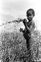 Karl Heider negatives, New Guinea; Milika's son making grass stem toys