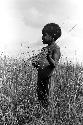 Karl Heider negatives, New Guinea; Milika's son making grass stem toys