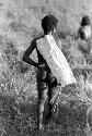 Karl Heider negatives, New Guinea; Young man with a long sheet of white paper