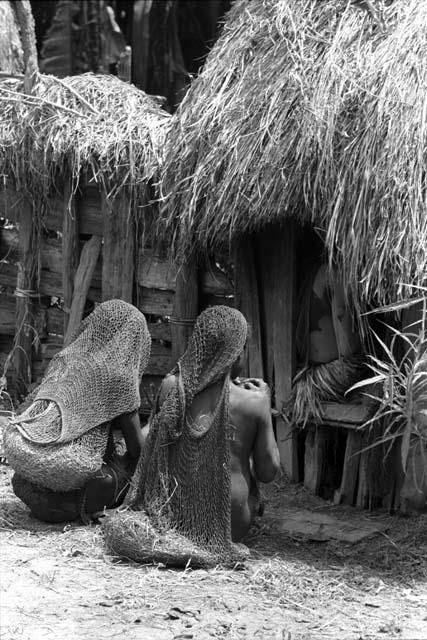 women mourning outside house at funeral of Dlatuk's baby at Asuklokoima