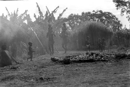 women and children in funeral yard.