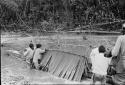 Showing method of building palm leaf shelter on canoe, used by travellers
