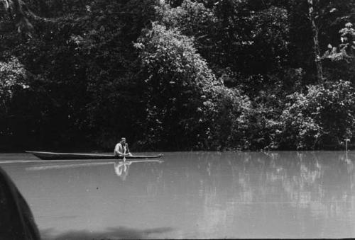 Koto indian paddling a canoe