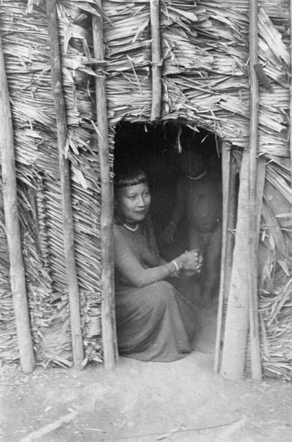 Woman and child showing size of house door