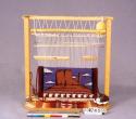 Miniature loom scene with pictorial textile