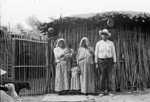 Owner of Yaqui family in front of house