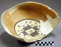 Ceramic partial bowl, black on yellow interior, flared rim, reconstructed