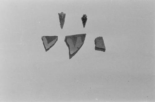 Sack 55. Top row: flint arrowhead, obsidian point, bottom row: black on gray ware