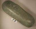 Elongated, somewhat cylindrical cobble. one end highly polished with striations.
