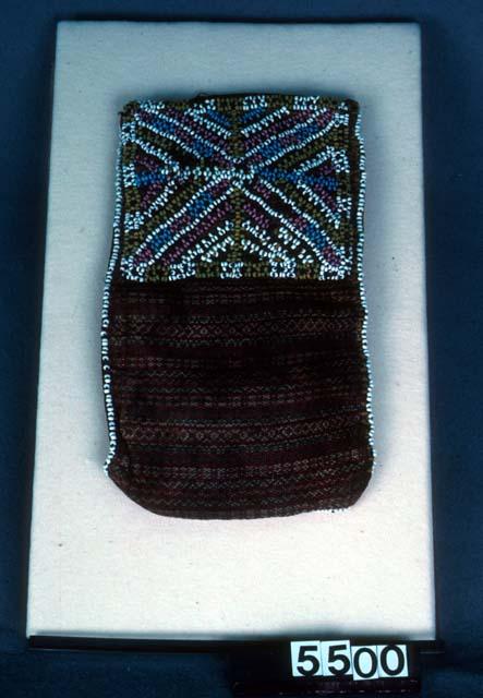 Small cloth bag, edged with white beads, half of one side is heavily beaded in a