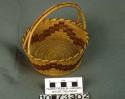 Coiled bowl-shaped basket with straight sides and handle