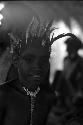 Boy watches a dance from under the olea