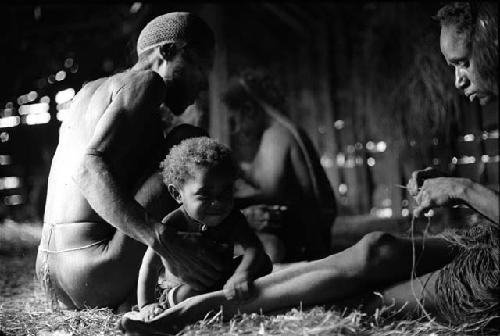 Man, woman, and child in hunu