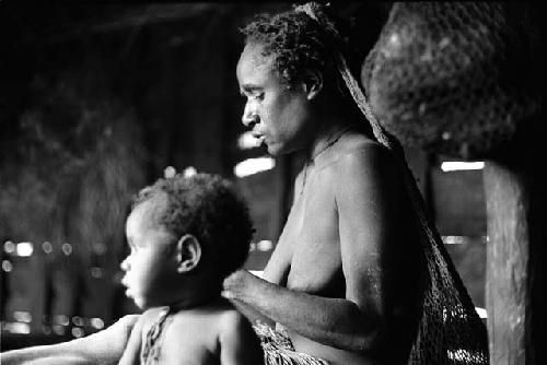 Woman and child inside a hunu