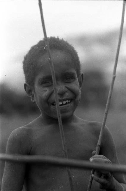 Portrait of a small boy smiling; head and shoulders