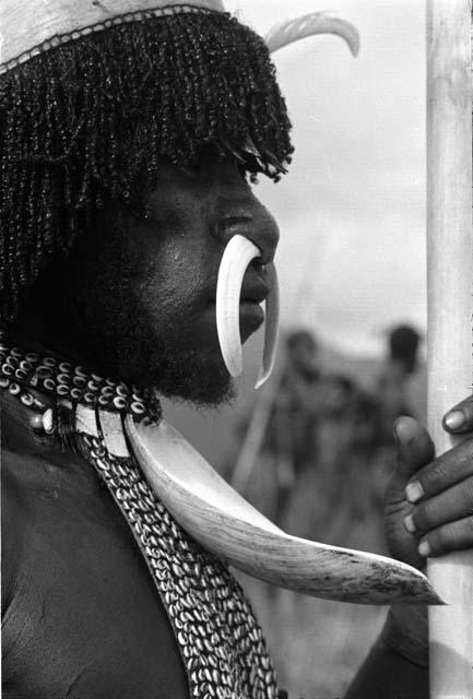 Portrait of Teku with mikak, walimoken and the wamaik in his nose; he holds a spear