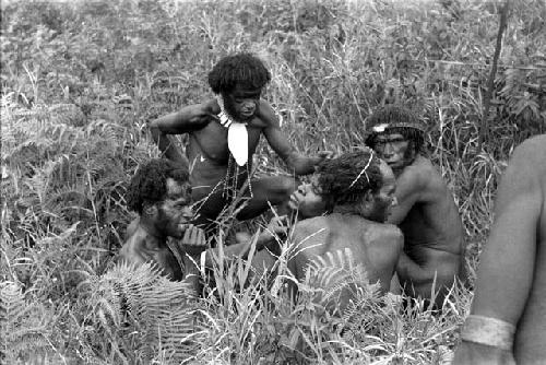 Warriors removing arrow from another's shoulder