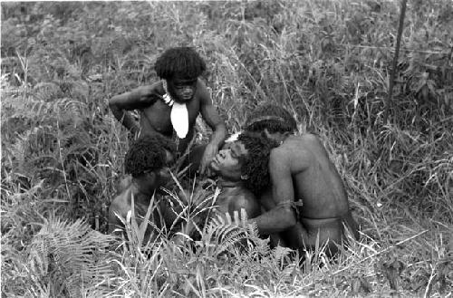 Warriors removing arrow from another's shoulder