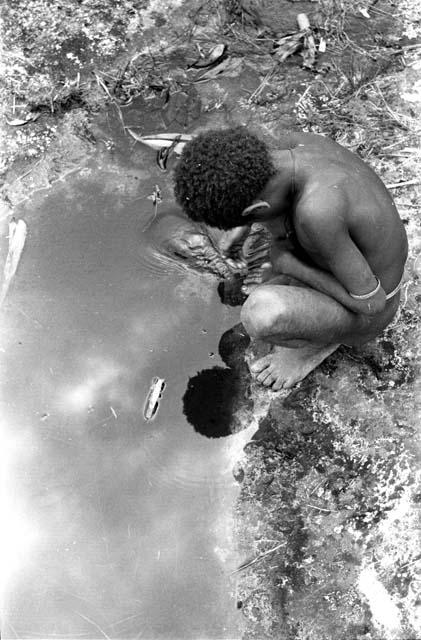 Child looking into pool