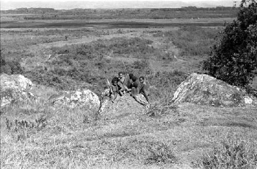 Children playing on a rock