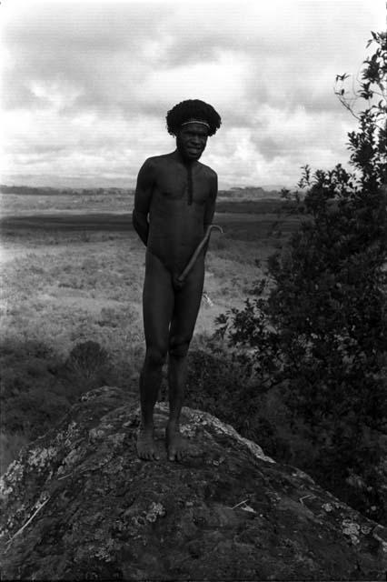 Man standing on a rock above the valley on the Tukumba