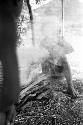 Two figures blurred by smoke