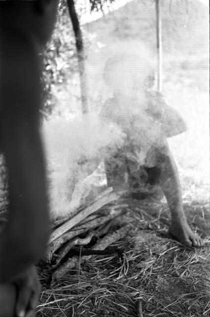 Two figures blurred by smoke