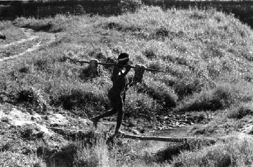 Man crossing a ditch