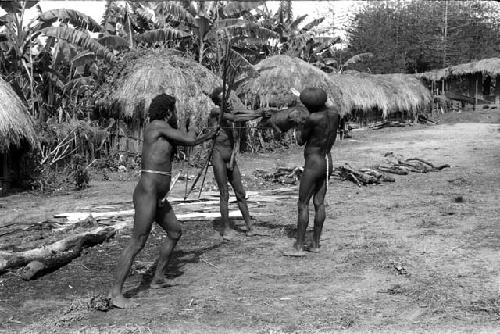 Men shooting a pig