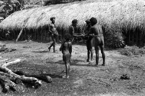 Men holding a pig to be shot