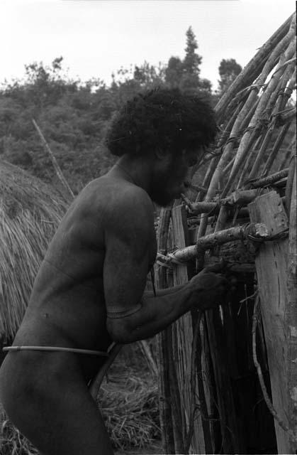 Man working on honai