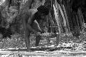 Man using wooden tools