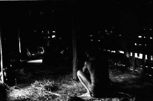 Boy watches women tend to a corpse