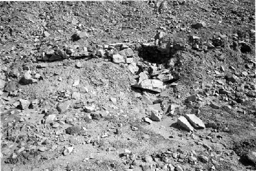 Back wall of upper terrace showing melted adobe and rocks at Site 93