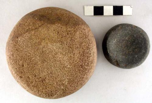 Ground stones, discoidal, one convex on top and botton