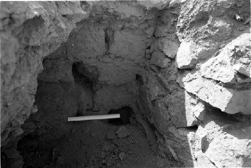 Rectangular adobe brick wall abutting coursed angular rock wall at Site 133