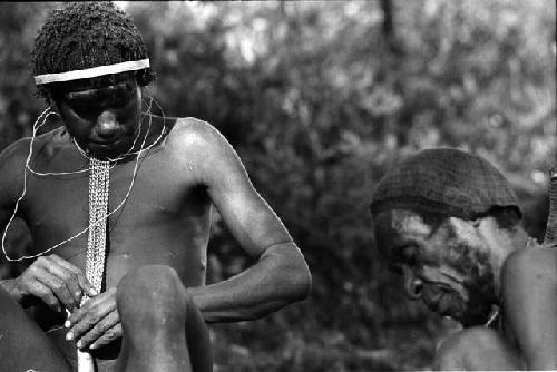 Siloba sitting with an old man