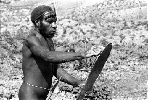 Apeori cleans his digging stick